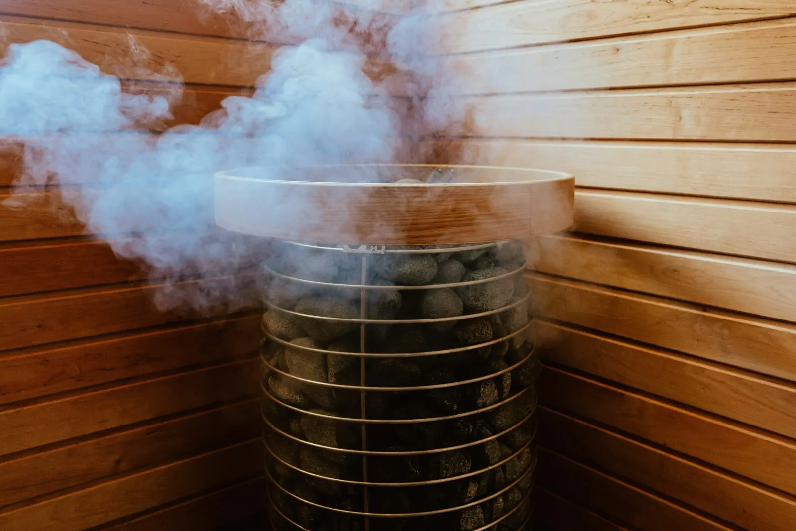 Steam rising from a stove in a wooden sauna