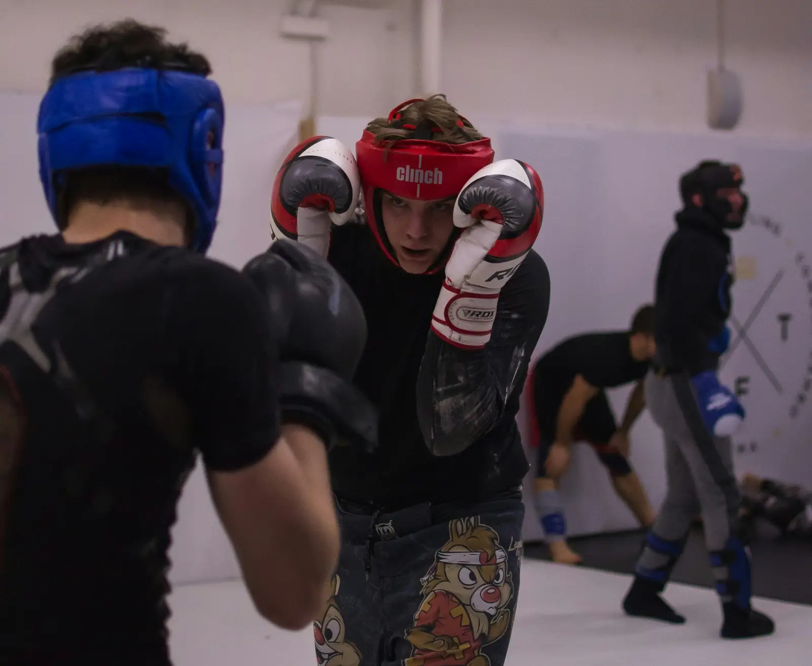 Fighter in headgear with a high guard during sparring
